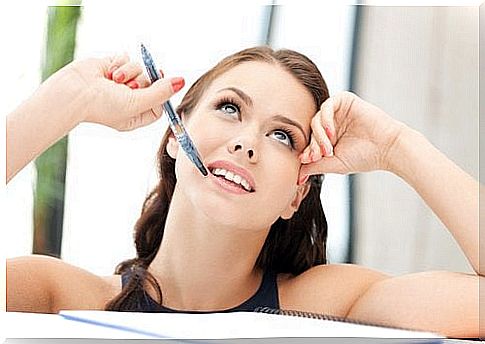 Woman sitting and writing a letter