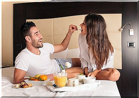 Couple eating in bed