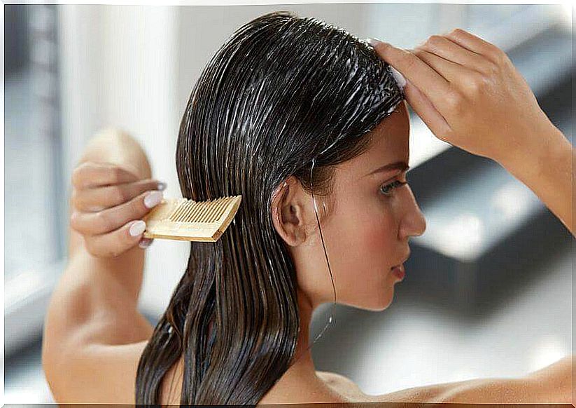 Woman arranging her hair - long and healthy hair