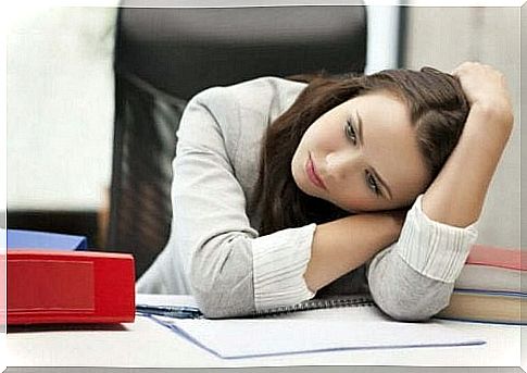 Tired woman at work resting on table