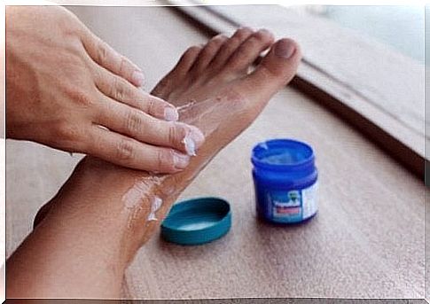 Person smearing menthol ointment on his feet