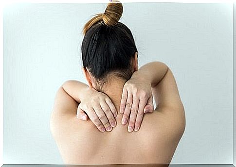 Woman with muscle pain in the back