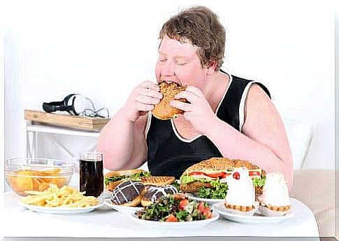 Obese person with a lot of food in front of him could benefit from adjustable gastric banding