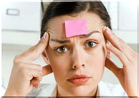 Woman with piece of paper in forehead