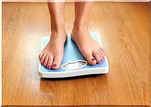 Woman standing on a bathroom scale