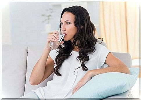 woman drinking a glass of water