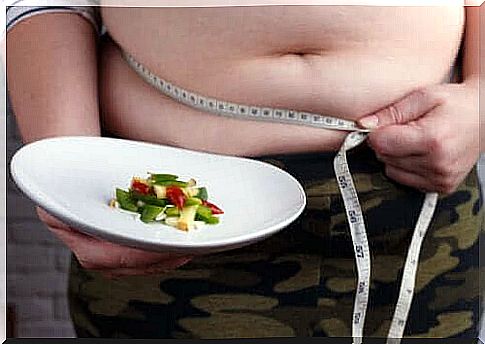 Person with small meal and measuring tape about stomach