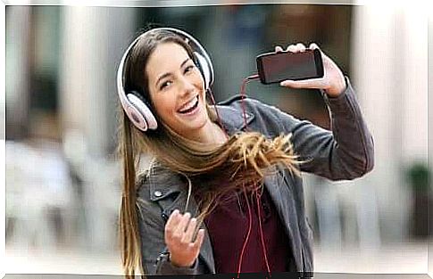 Smiling woman listening to music on headphones