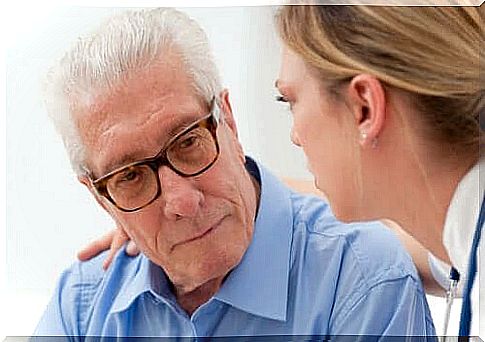 Woman trying to help an elderly person with an illness