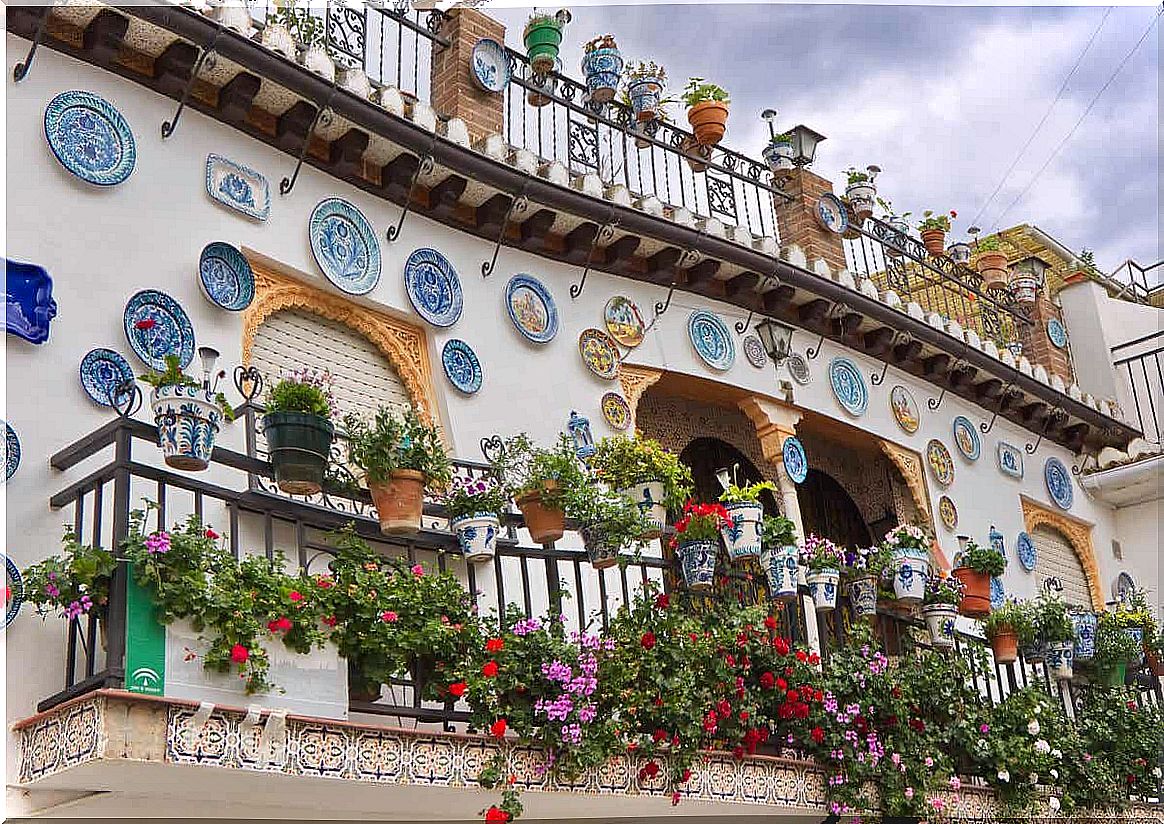 A balcony in Andalusian covered with ceramic flower pots and plates