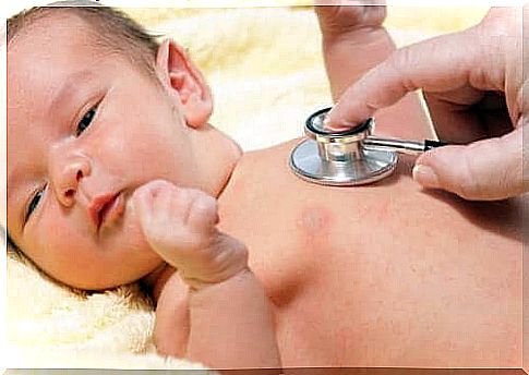 Newborn baby is checked by a doctor