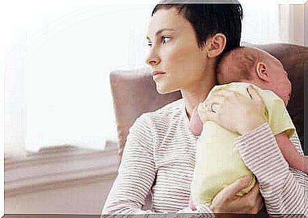 Sad mother with baby is example of how to recognize a postpartum depression