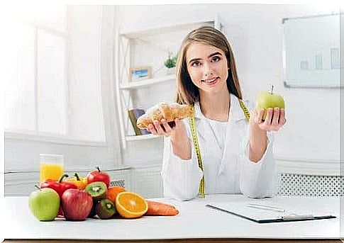 Nutritionist sits with fresh fruits to encourage reducing the intake of sugar