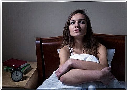 Woman sitting in bed - nocturnal panic attack