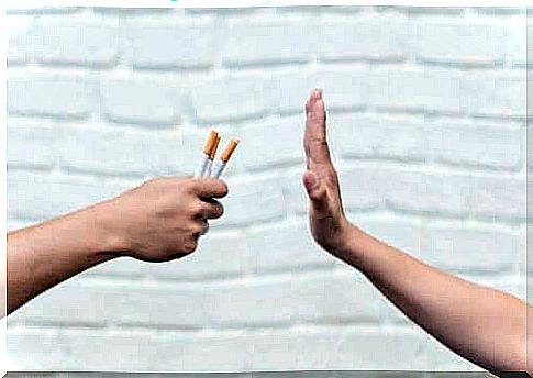 Hand says no to cigarettes as a symbol of smoking cessation