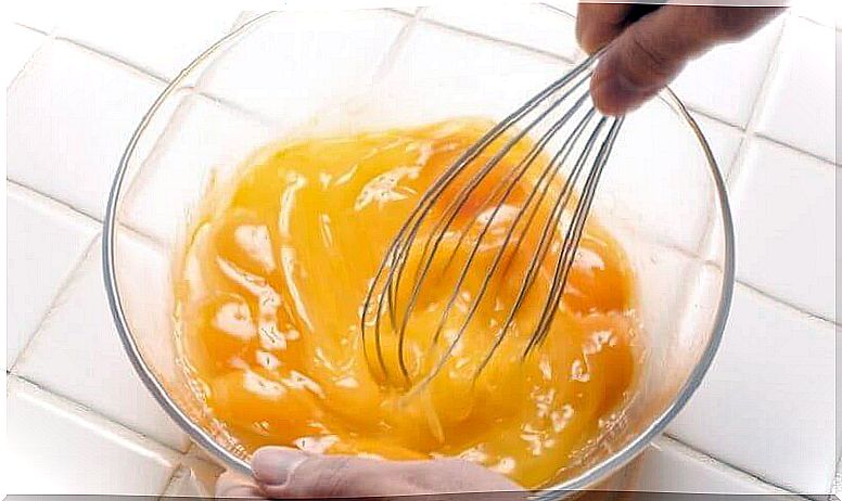 Eggs are stirred with whisk.