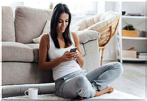 Woman sitting with phone in hand