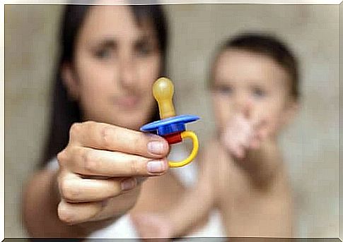 Mom takes pacifier from baby