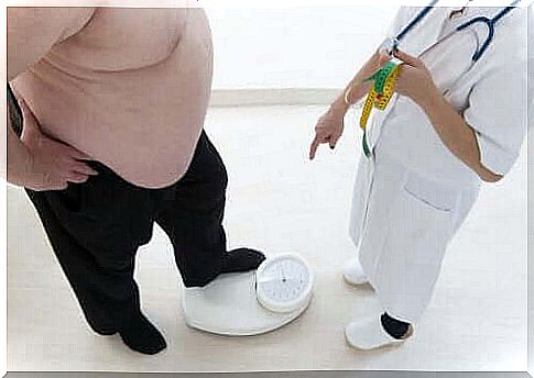 Obese person is weighed by the doctor