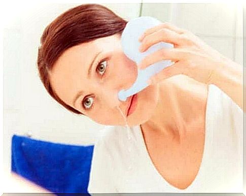 Woman rinses her nose with water