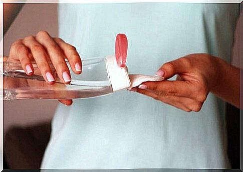 Woman getting micellar water on cotton ball