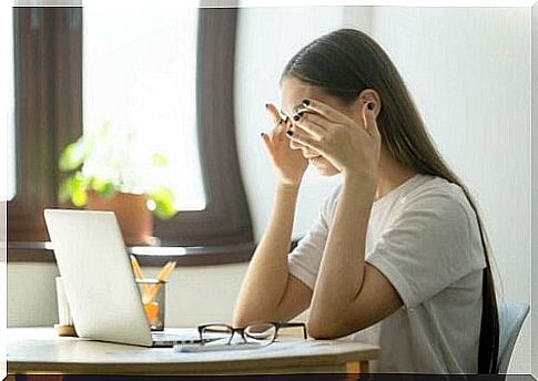 Woman with headache at computer