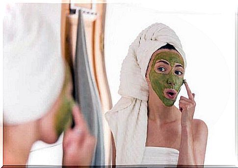 Woman applying face mask